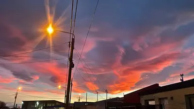 an orange sunset burning over the rooftops