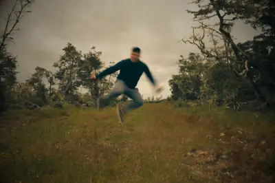 someone caught mid-jump in an open field