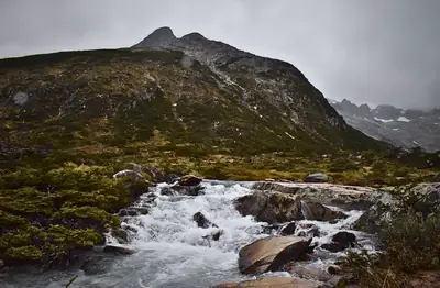 rapids between grey boulders